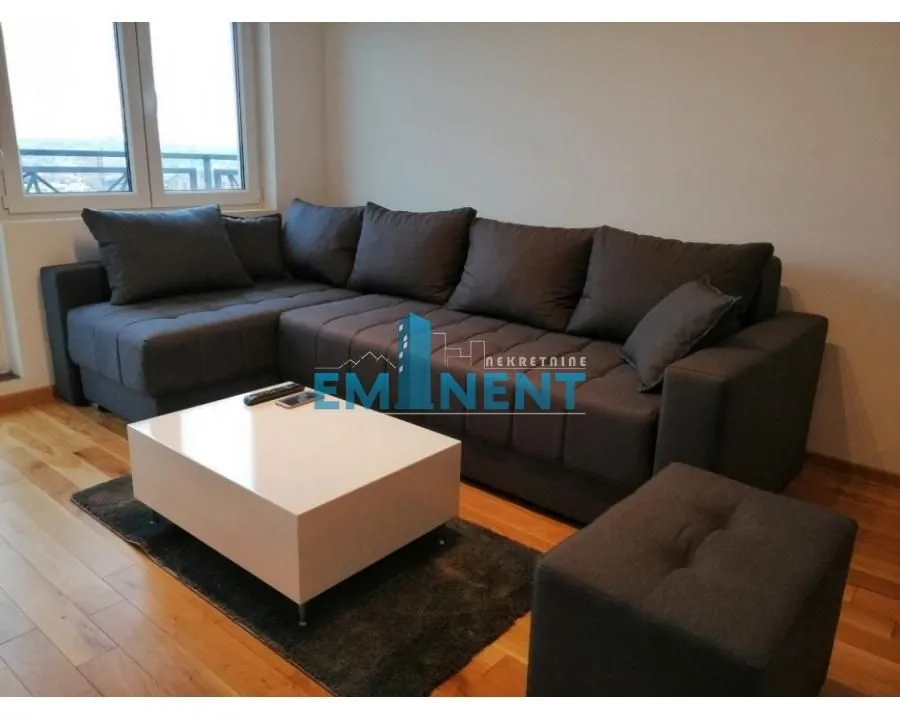 Living room with a corner sofa and a white coffee table.
