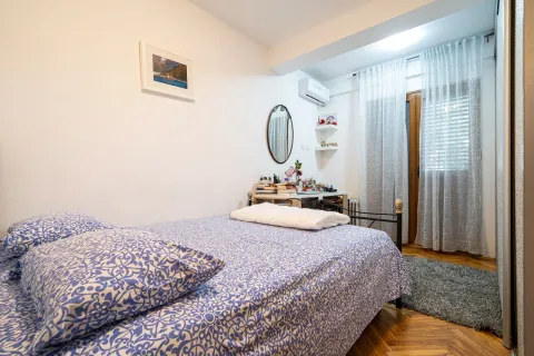 A bright bedroom with a double bed and a writing desk. - image 28