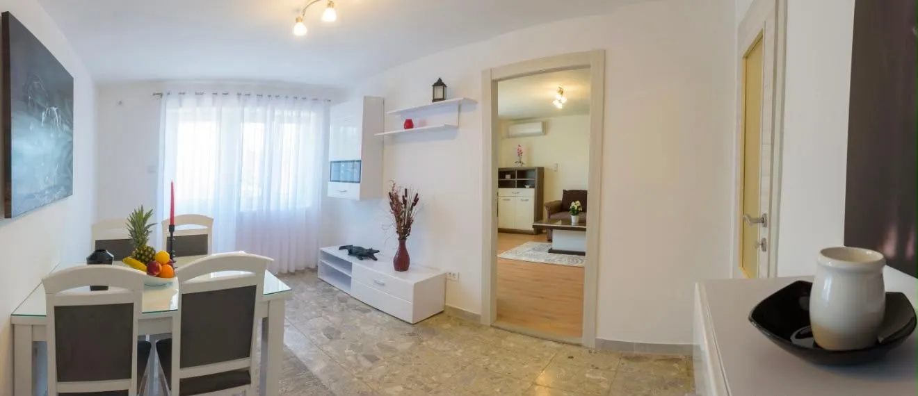 Spacious living room with a dining area and light furniture.