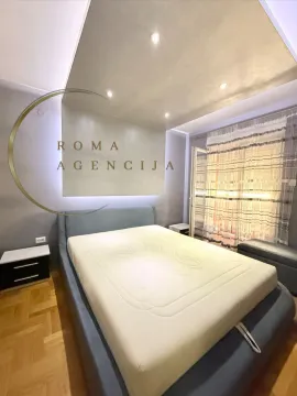 Modern bedroom with a double bed and a drop ceiling with lighting. - image 8
