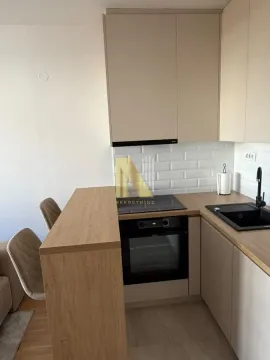 Smaller kitchen with built-in units and a breakfast bar. - image 12