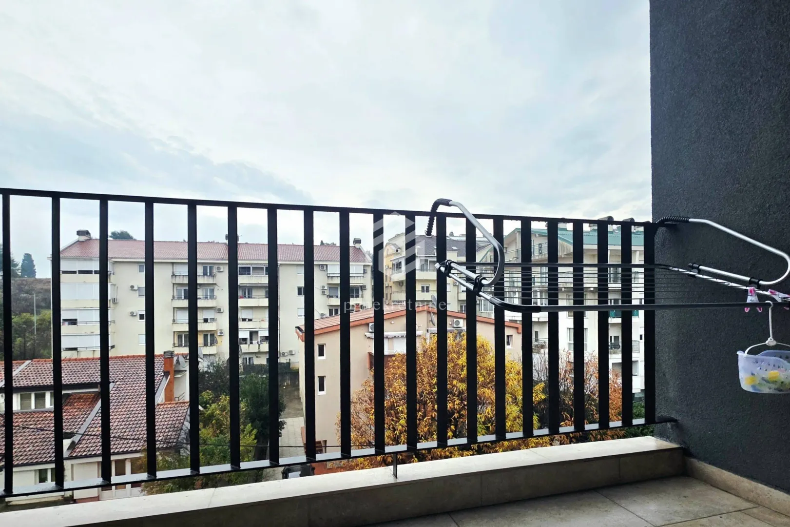 View from the balcony overlooking surrounding buildings and neighborhood.