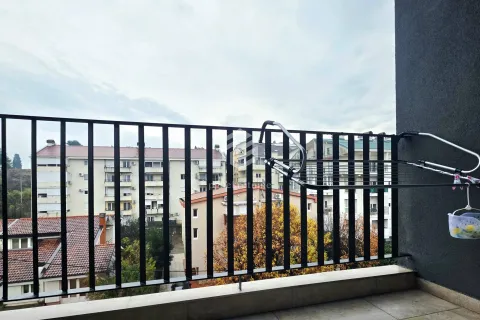 View from the balcony overlooking surrounding buildings and neighborhood. - image 7