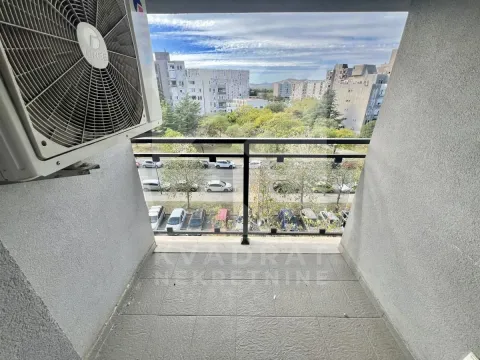 View from the balcony overlooking the city street and parking area. - image 8