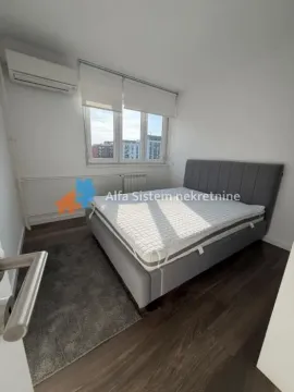 Bedroom with a double bed, window, and air conditioning. - image 9
