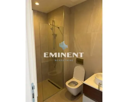 Modern bathroom equipped with a walk-in shower and a wall-hung toilet. - image 11