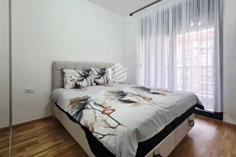 Furnished bedroom with a double bed and a window with curtains. - image 5