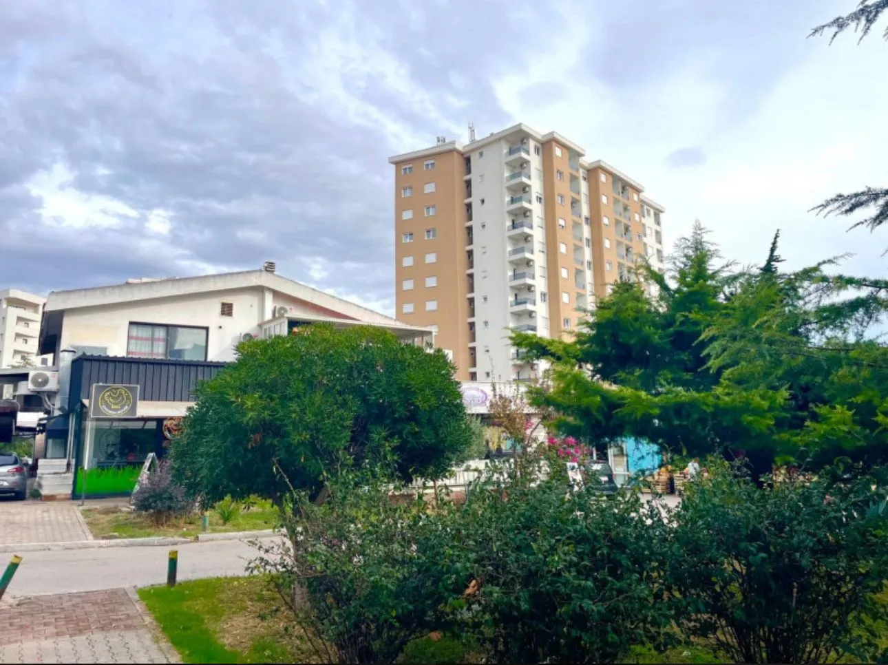 View of a residential building and surrounding greenery.