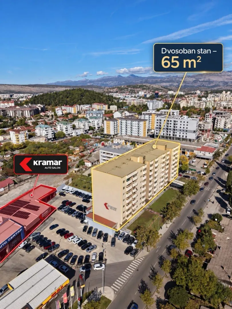 Pogled iz vazduha na stambenu zgradu sa okolinom.