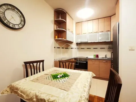 Kitchen with a dining table and wooden cabinets. - image 4