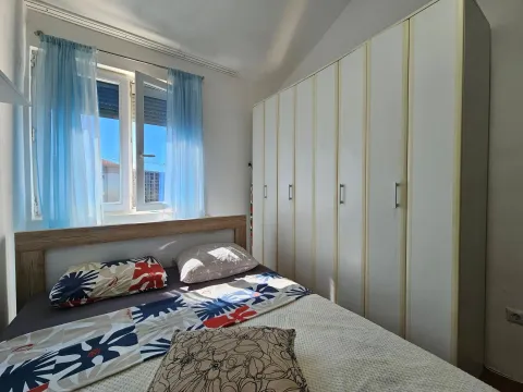 Bedroom with a double bed, window, and a large built-in wardrobe. - image 8