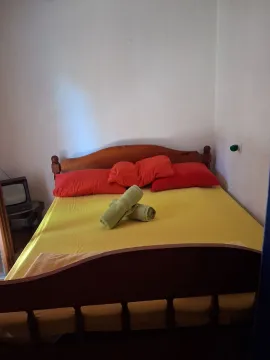 Bedroom with a double bed and neatly folded towels. - image 7
