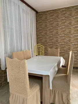 Dining room with a table, chairs, and a decorative wall. - image 8