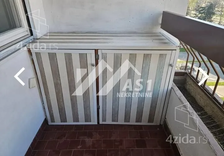 Balcony with a built-in cabinet and street view.