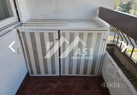Balcony with a built-in cabinet and street view. - image 8
