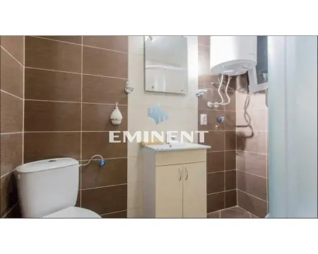 Bathroom equipped with sanitary ware, a vanity with a sink, and a water heater. - image 7