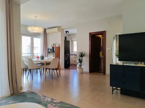 Spacious living room with a dining area and a TV console. - image 3