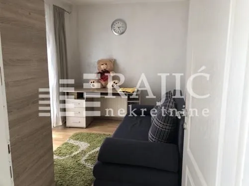 Living room with a sofa and a desk.