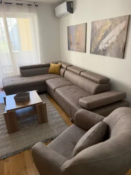 Living room with a sectional sofa, armchair, and coffee table. - image 3