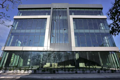 Modern office building with a glass facade. - image 4