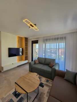Modern living room with a sofa, TV, and access to the terrace. - image 8