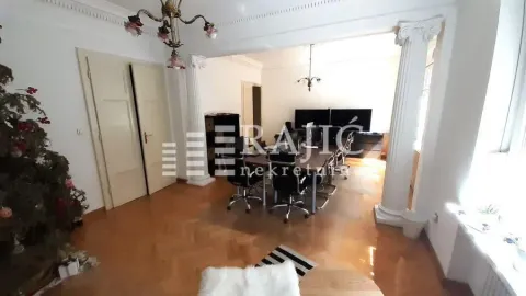 Spacious living room with a dining table and columns. - image 7