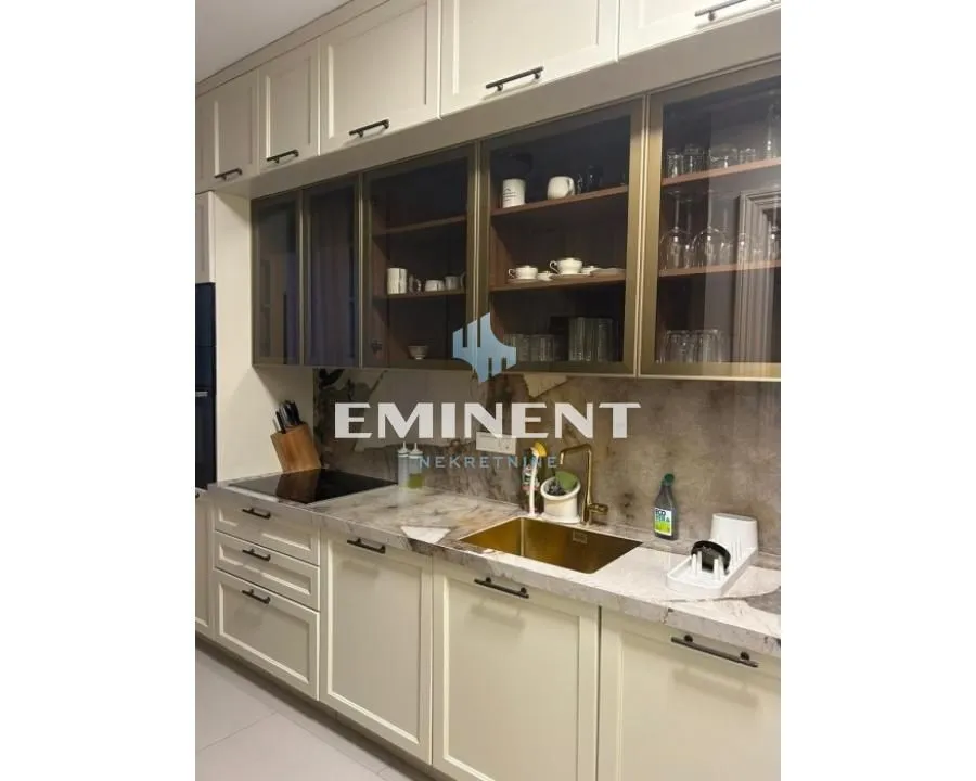 Modern kitchen with light-colored cabinetry and a built-in cooktop.