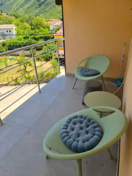 Furnished balcony with seating set and greenery view. - image 5