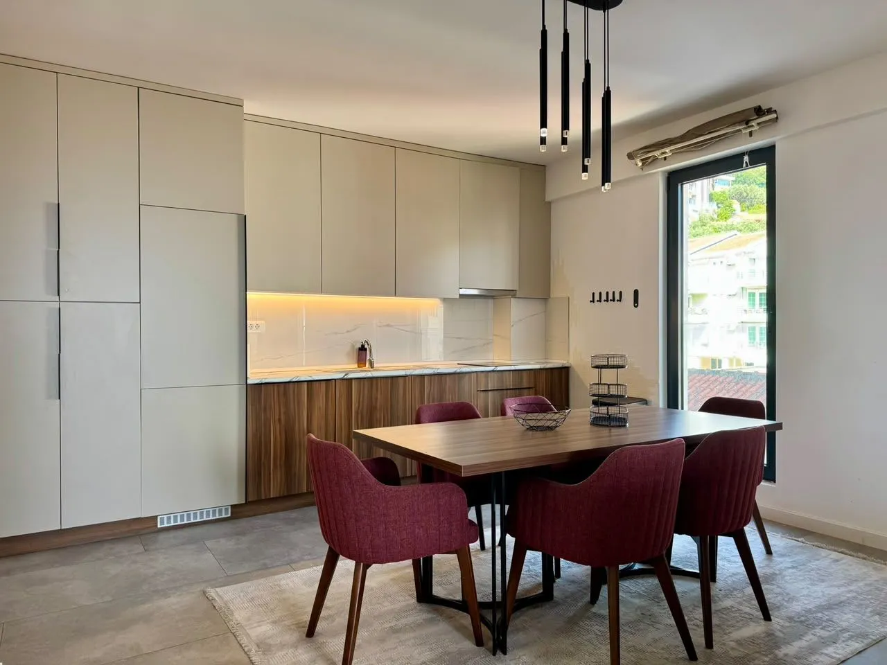 Modern kitchen with a dining area and built-in units.