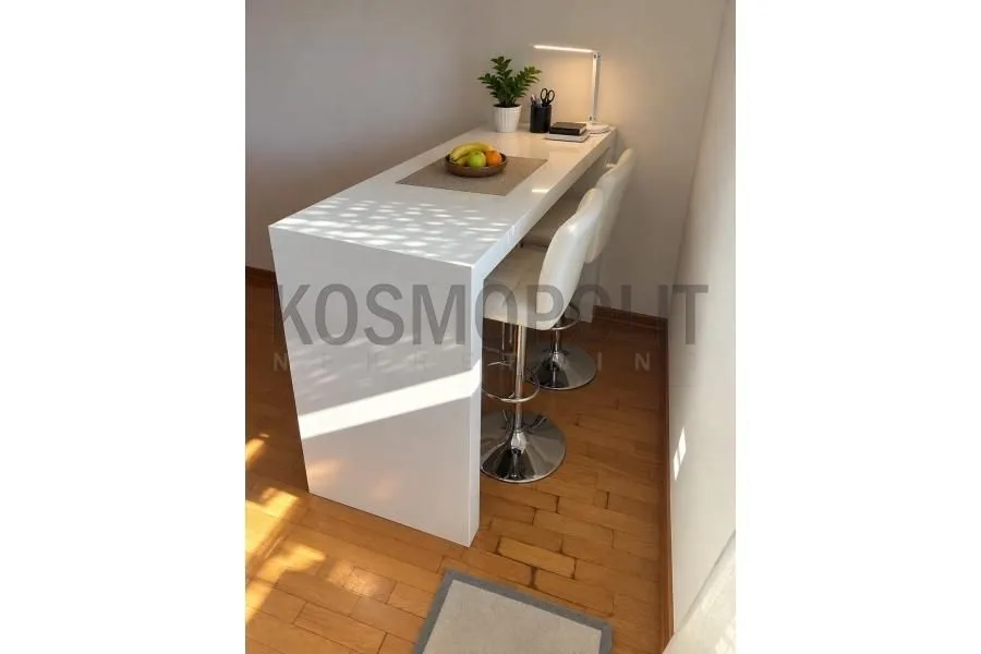 White kitchen bar with bar stools and a corner desk.