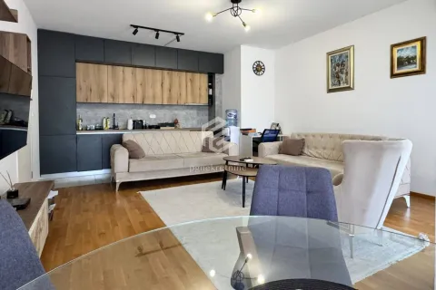 Living room with sofa set, dining table, and kitchen in the background. - image 5