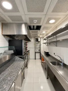 Commercial kitchen equipped with professional stainless steel appliances and work surfaces. - image 19