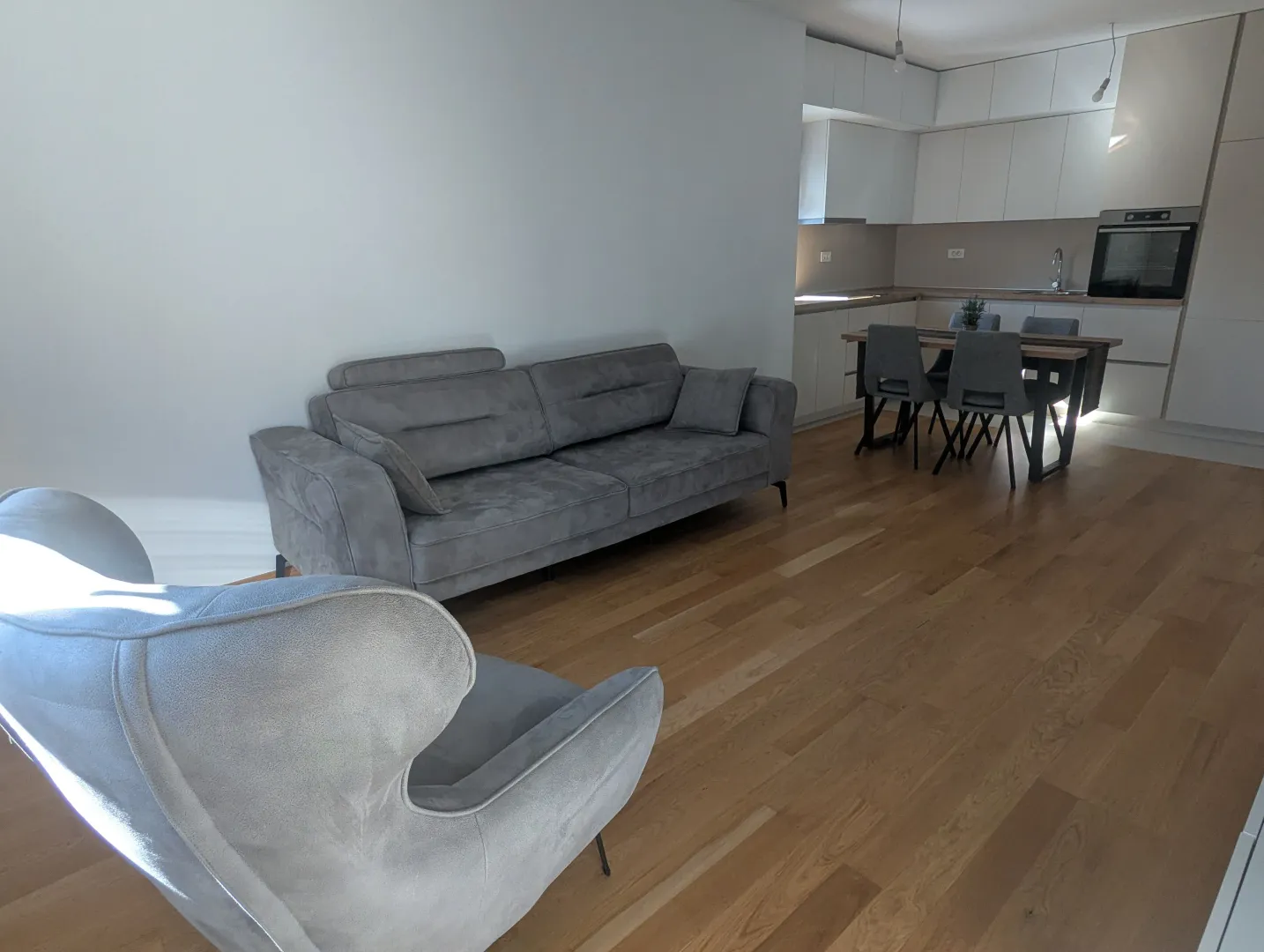 Living room with a sofa set and a dining area beyond.