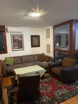 Dnevna soba sa ugaonom garniturom, foteljama i šarenim tepihom. - image 5
