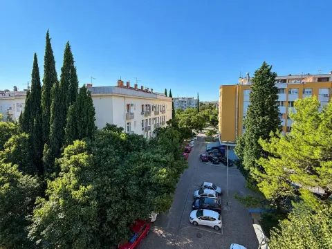 View from the apartment on surrounding buildings and greenery. - image 8