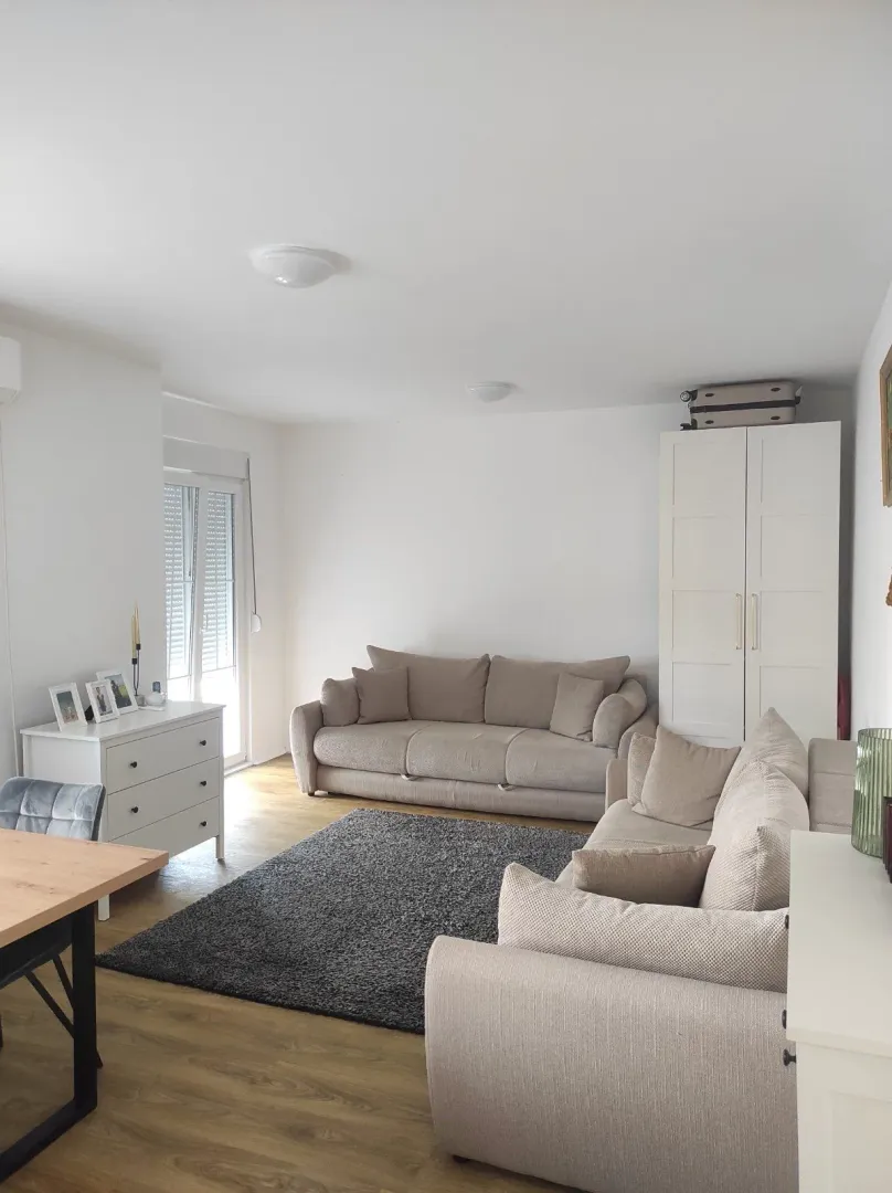 Bright living room with a sofa set and modular furniture.
