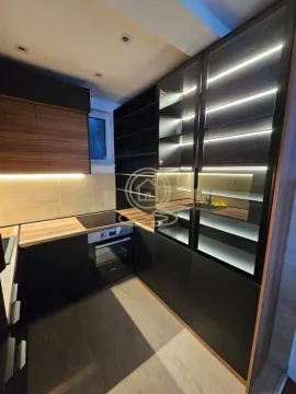Modern dark-toned kitchen with built-in appliances and integrated lighting. - image 3