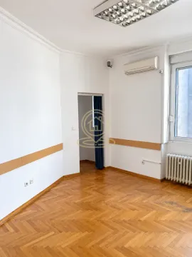 Empty office room with white walls, parquet flooring, and an air conditioning unit. - image 7