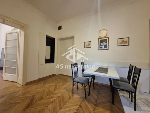 Dining area with a dining table, chairs, and parquet flooring. - image 9