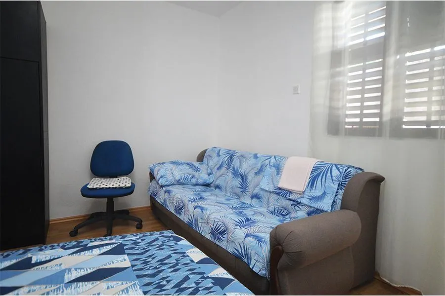 Living room with a sofa and an office chair.