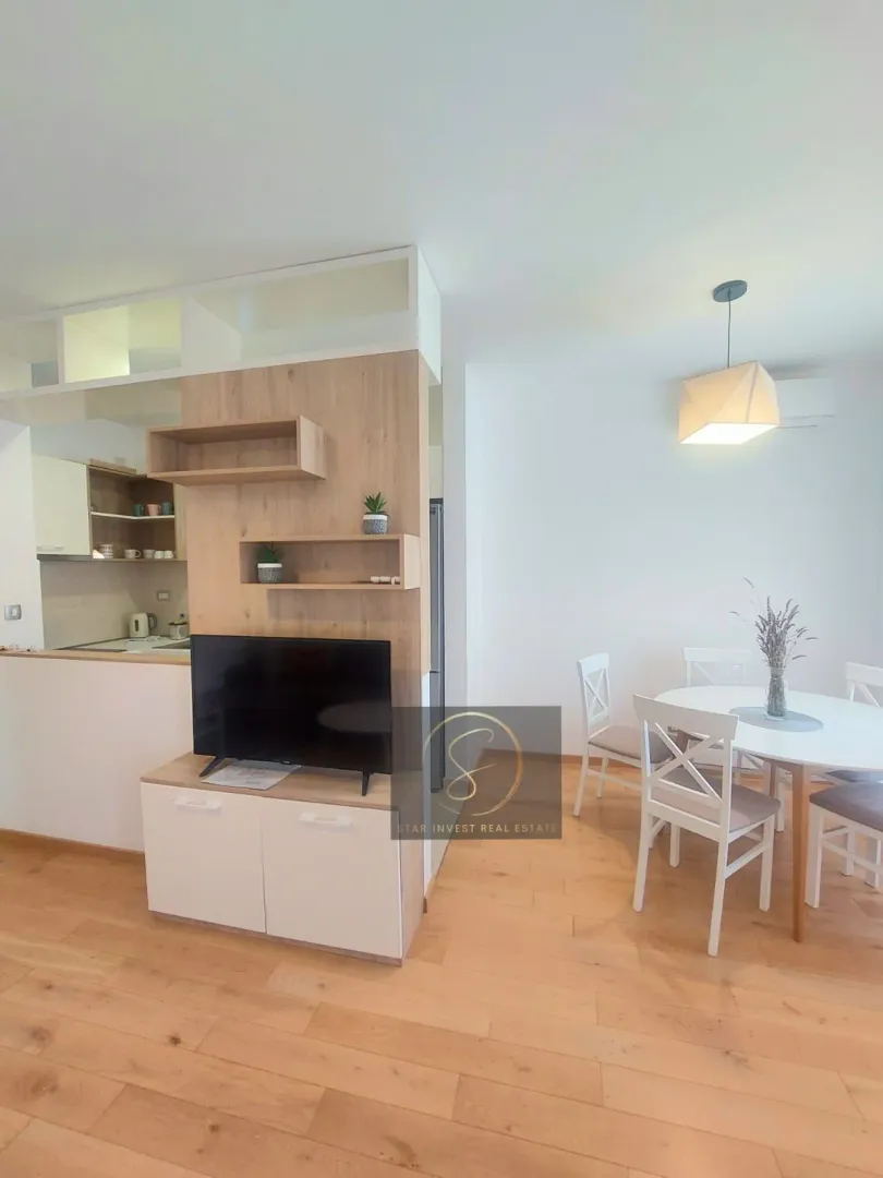 Living room with dining area and view of the kitchen.