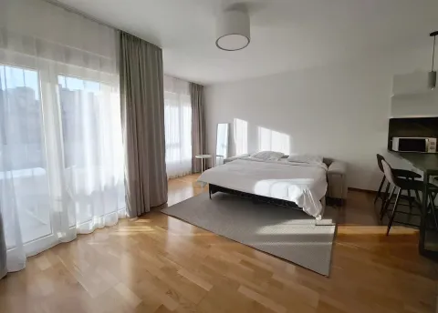 Bright bedroom with a double bed, wooden floor, and terrace access. - image 11