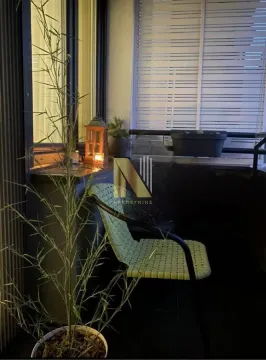 Uređena terasa sa stolicom, biljkama i lampionom. - image 21