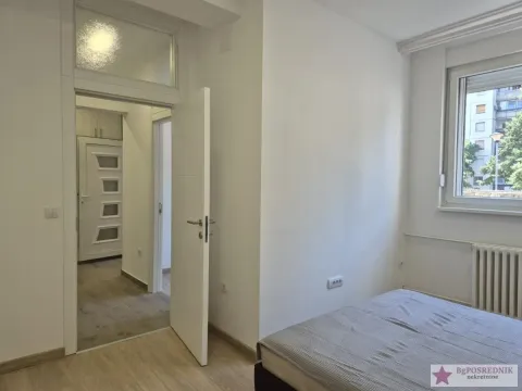 Bedroom with a bed and a view through the window. - image 4