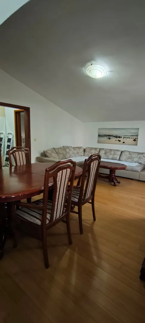 Living room with dining area and sofa set.