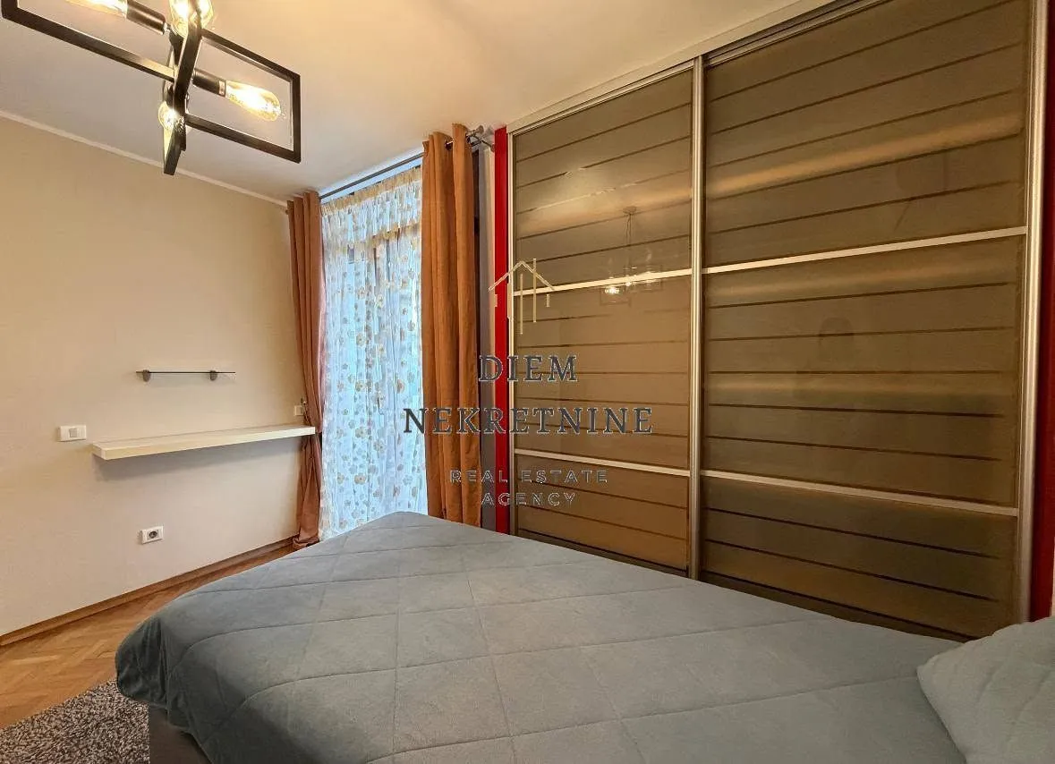 Furnished bedroom with a large wardrobe and a double bed.