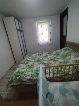 Bedroom with a double bed, wardrobe, and a baby cot. - image 8