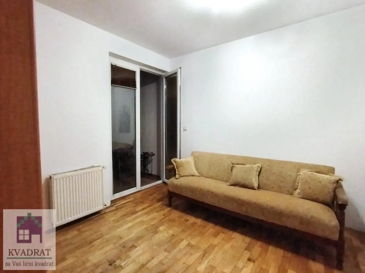 Living room with a sofa and access to the terrace.