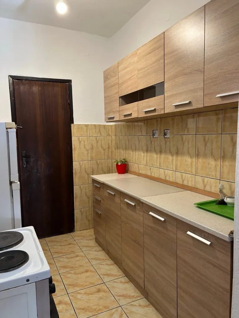 View of the kitchen with wooden cabinets and tiling.
