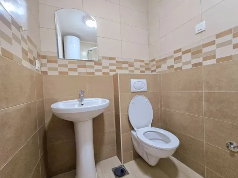 Small bathroom with a sink, toilet, and mirror. - image 4